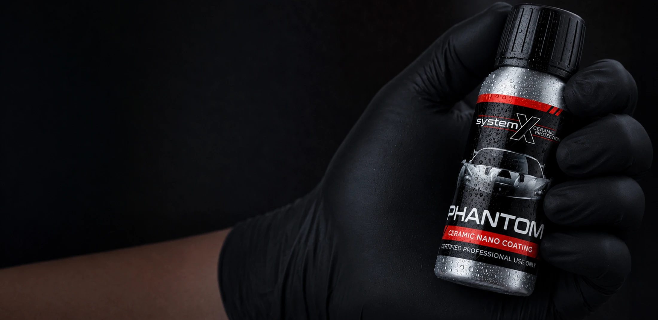 A professional holding a System X Phantom ceramic coating bottle